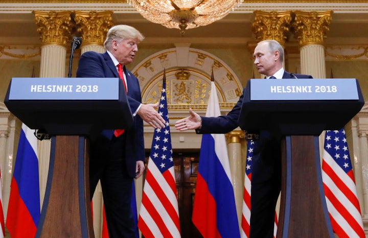 President Donald Trump and Russian President Vladimir Putin shake hands during a joint news conference after their meeting in Helsinki on Monday.