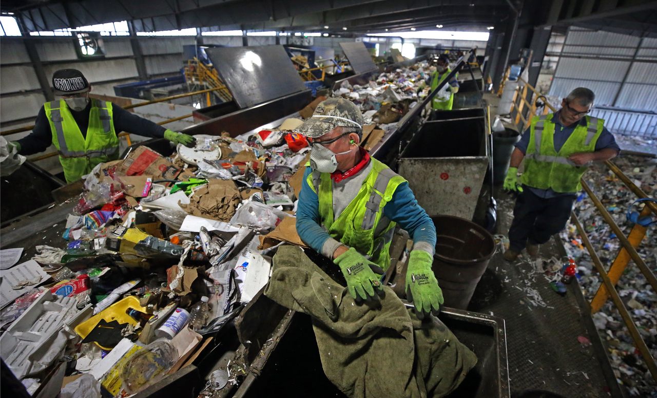 Trash is separated on a conveyor belt at E.L. Harvey & Sons in Westborough, Massachusetts, on May 31. The company says it's been forced to stockpile thousands of tons of recyclables since January.