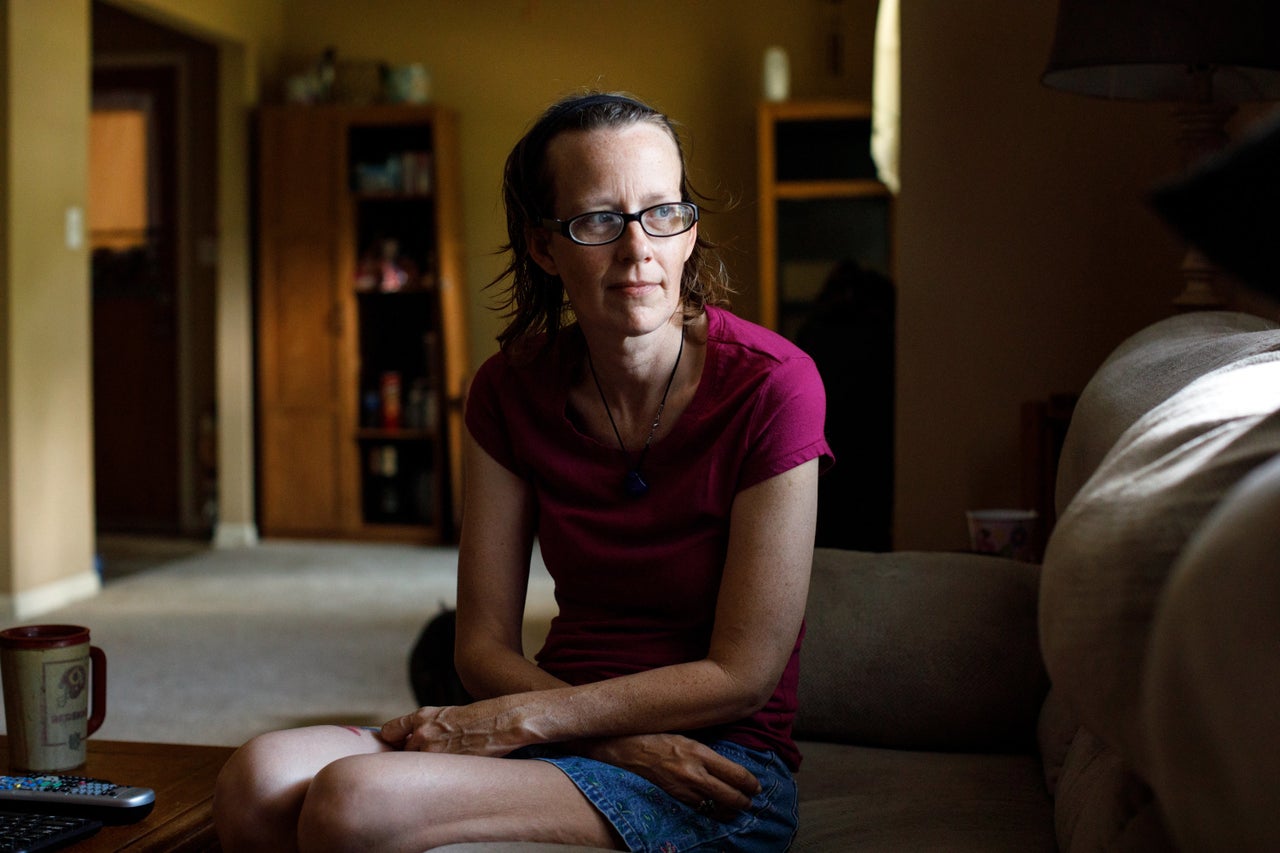 Meredith Lawrence sits in the living room of the home in Gainesville, Georgia, that she bought after her husband's death.