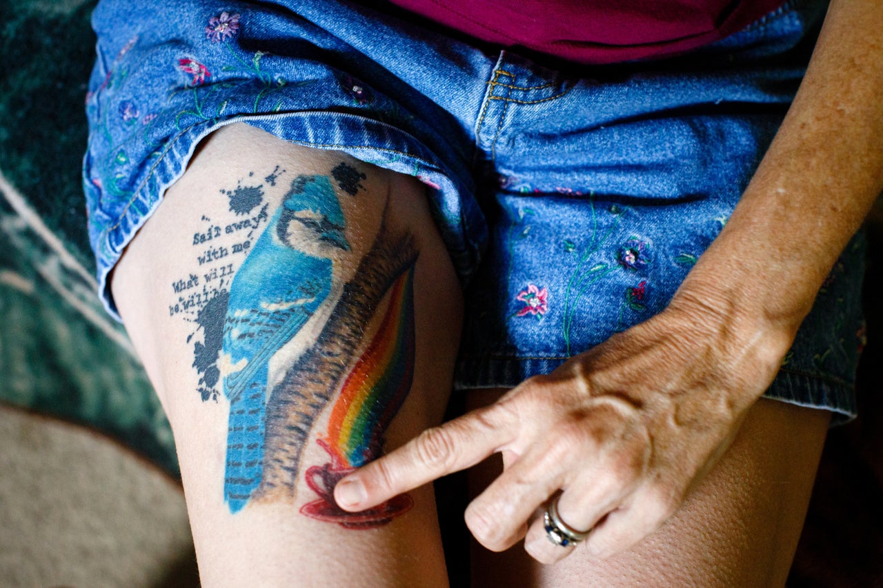 Meredith Lawrence shows the tattoo she got after her husband's death. The bluejay represents her husband, Jay; a cup of coffee is the way she loves to start her day; and the quote is "Sail away with me, what will be will be."