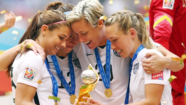 United States Alex Morgan, Lauren Holiday, Abby Wambach and Whitney Engen celebrate winning the World Cup following the FIFA Women's World Cup Canada 2015 Final match between USA and Japan at BC Place Stadium in Vancouver, Canada.