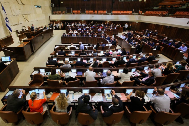 Israeli members of Parliament attend the Knesset Plenary Hall session ahead of the vote on the law that establishes Jewi
