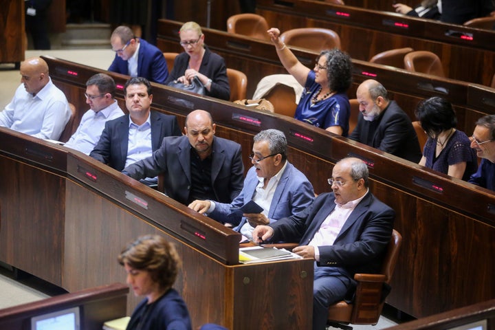 Israeli-Arab Member of Parliament Ahmed Tibi (front row, right) with fellow deputies at the Knesset Plenary Hall session ahead of the vote on a national law defining Israel as the nation state of the Jewish people.