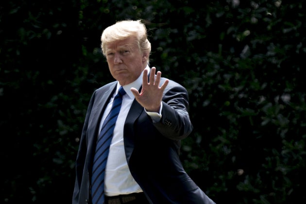 U.S. President Donald Trump waves while walking on the South Lawn of the White House before boarding Marine One in Washington, D.C.