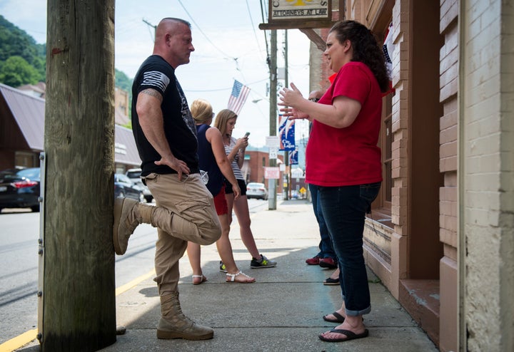 Richard Ojeda speaks with campaign volunteer Heather Ritter, 39, outside his campaign headquarters in Logan, West Virginia, J