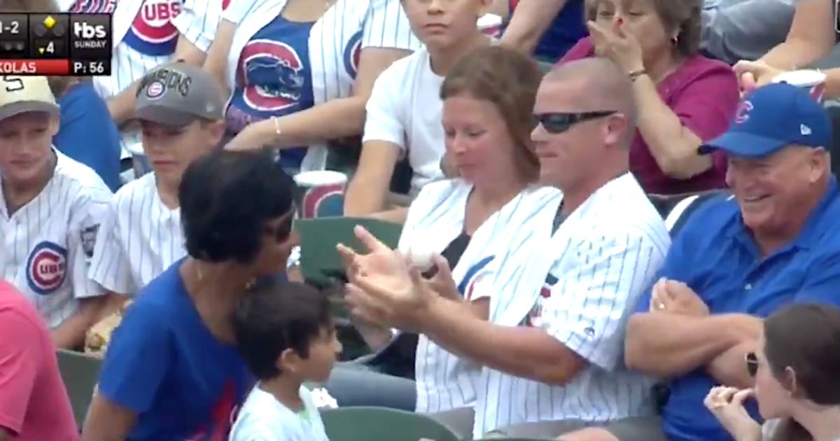 Cubs fan holds baby in one hand, interferes with foul ball with other -  Sports Illustrated
