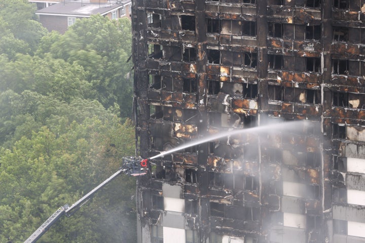 Firefighters working to extinguish the 24-storey blaze at Grenfell Tower on June 14, 2017.