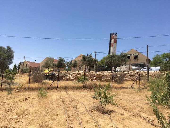 Large surburban styled houses and amply watered trees define the line between the Israeli settlements of Carmel and Umm Al-Khair.