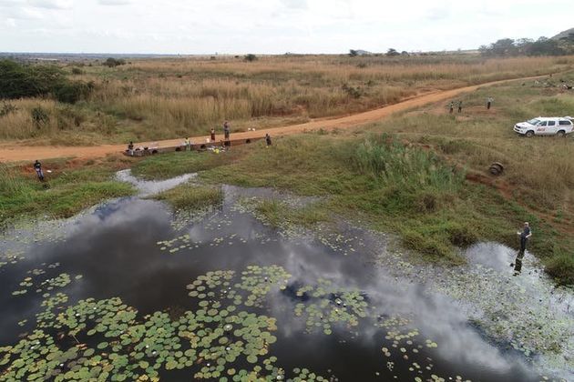 Image captured by the drone of the team taking samples at one of the surveyed reservoirs.