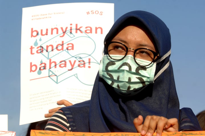 Women Action Committee during the protest against sexual violence in Indonesia, with the slogan "SOS," Save Our Sisters, in J