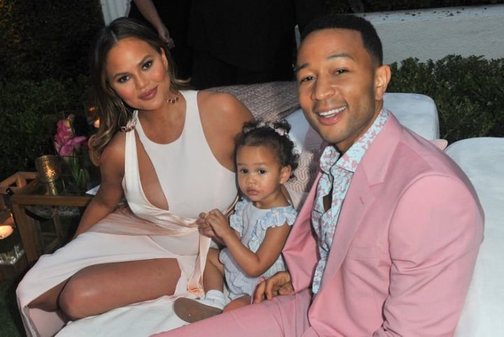 Chrissy Teigen — pictured with John Legend and their daughter, Luna — is having a stressful flight. 