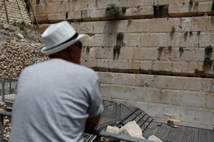 A man looks at the stone that fell from the Western Wall on Monday.