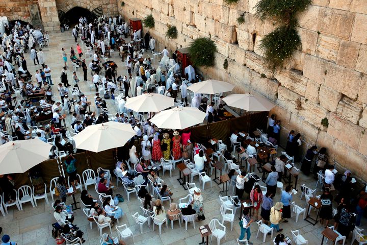 Jewish women pray at the women's section, on the right, which is separated from the men's section of the Western Wall.