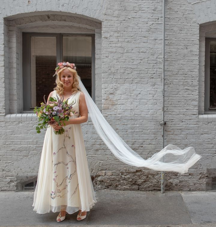 Caroline Millin-Brawn wore a 1970s second-hand white dress with hand painted silk flowers to her wedding.