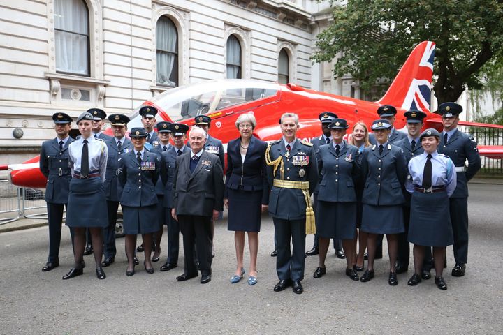 Theresa May poses with a replica of a Hawk jet used by the Royal Air Force Aerobatic Team 'Red Arrows'.