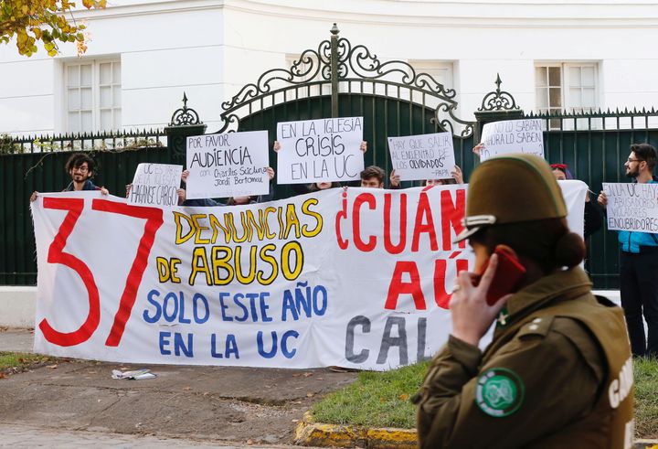 Demonstrators hold a banner that reads, "37 allegations of abuse this year at the Catholic University", in front of the apostolic nunciature where Special Vatican envoys archbishop Charles Scicluna and father Jordi Bertomeu are at, in Santiago, Chile June 13, 2018.