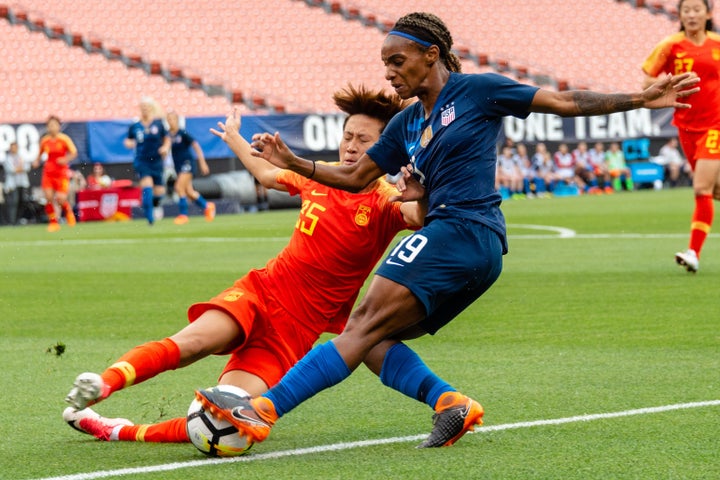 Lou Jiahui (left) of China battles with Crystal Dunn of the U.S. in Cleveland on June 12, 2018. Compared with male players, female players get paid less and have fewer resources.