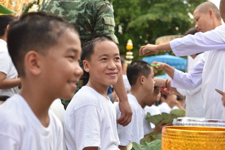 Buddhist monks cut the hair of members of the Wild Boars soccer team.