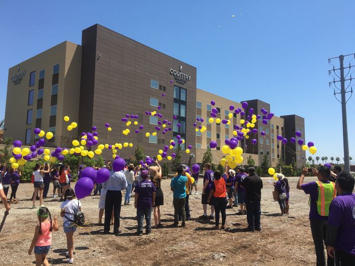 Yellow and purple balloons are released in celebration of a tentative deal that promises better wages for Disney employees.