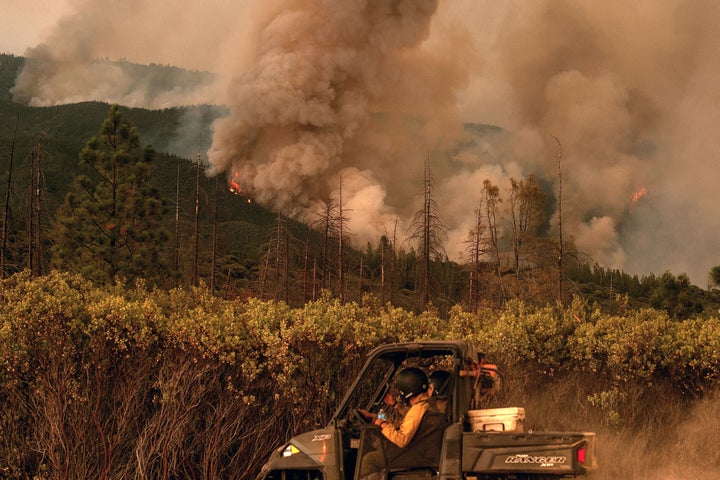 Firefighters drive along a fire break as the Ferguson fire burns in Stanislaus National Forest near Yosemite National Park on July 21.