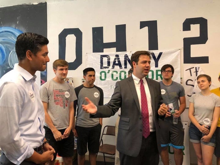 Democrat Danny O'Connor, center, speaks to campaign volunteers as Aftab Pureval, a Democratic candidate in Ohio's 1st, looks on at left.