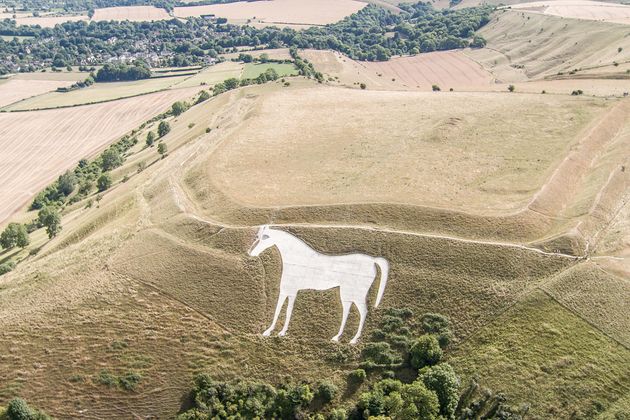 The English landscape, such as here surrounding the White Horse of Westbury, Wiltshire, is parched following weeks of dry weather 