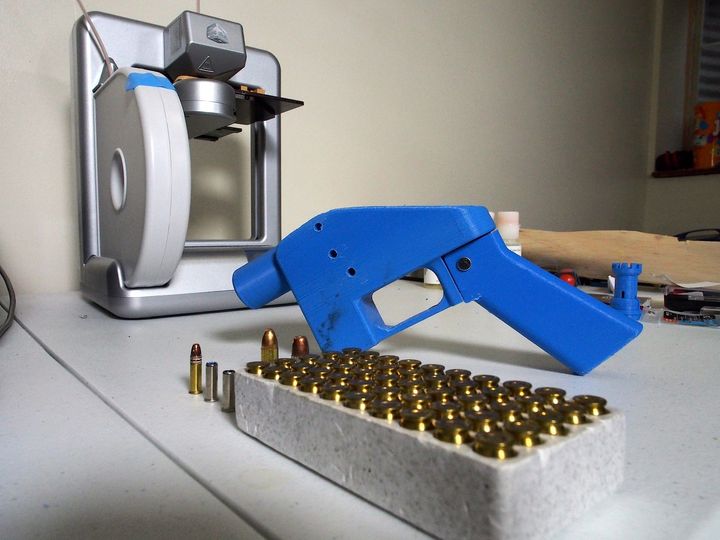 A Liberator pistol appears on July 11, 2013 next to the 3D printer on which its components were made. The single-shot handgun was the first firearm made entirely with plastic components forged with a 3D printer and computer-aided design (CAD) files downloaded from the internet.