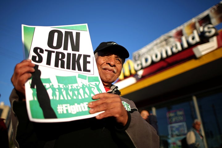 A worker participates in a "Fight for $15" wage protest in Los Angeles. The Birmingham City Council passed a measure in 2016 to raise the city’s wage floor from the federal level of $7.25 per hour to $10.10, but Alabama's legislature prevented it from going into effect.