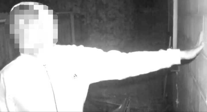 A still image from video of the suspect filmed outside the victim's residence. His face is blurred because police have arrested a juvenile in connection with the incident.
