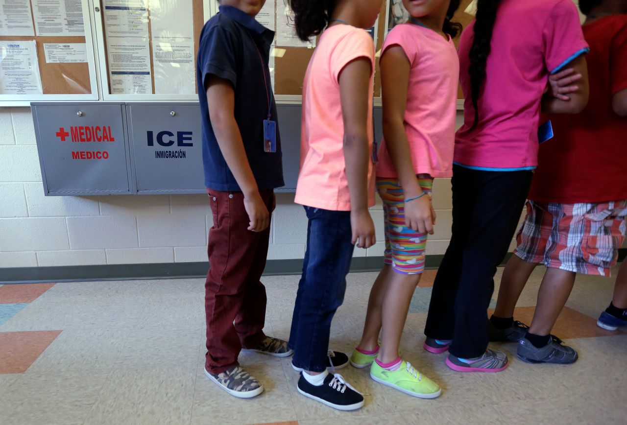 In this Sept. 10, 2014, file photo, detained immigrant children line up in the cafeteria at the Karnes County Residential Center in Karnes City, Texas. 
