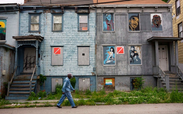 A man walks past boarded-up homes in Newburgh, New York, where massive PFOS contamination became the subject of multiple lawsuits earlier this year.