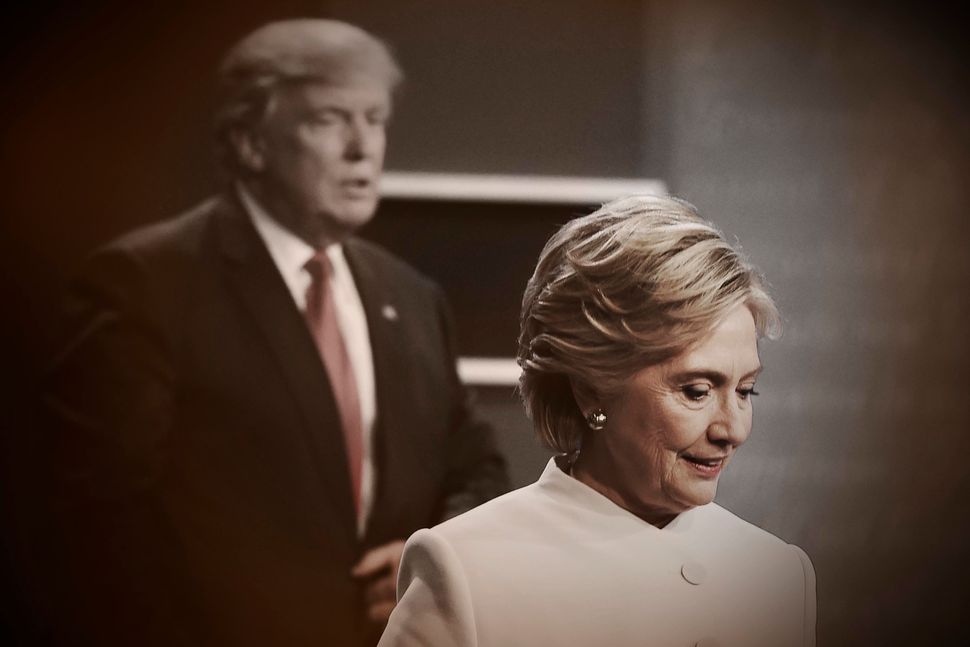 Democratic nominee Hillary Clinton and Republican rival Donald Trump walk off the stage after the final presidential debate in Las Vegas on Oct. 19, 2016.