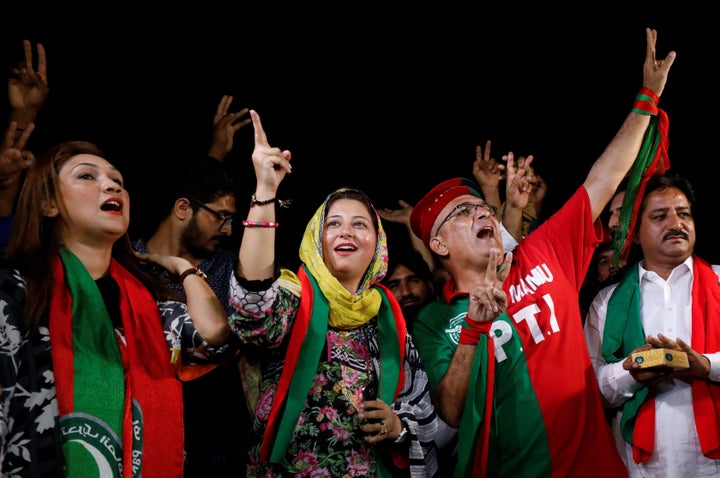 Supporters of Imran Khan, chairman of Pakistan Tehreek-e-Insaf (PTI), gesture to party songs, as they celebrate a day after the general election in Karachi, Pakistan July 26, 2018