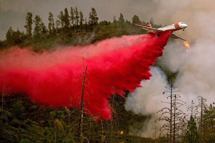 An air tanker drops retardant while battling the Ferguson fire on July 21 in Stanislaus National Forest, near Yosemite National Park, California. A fire that claimed the life of one firefighter and injured two others near Yosemite has almost doubled in size in three days, authorities said last week. 
