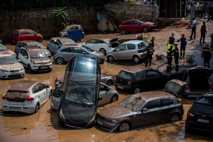 Vehicles are damaged in northern Athens on July 26, after a flash flood struck the Greek capital following deadly fires.