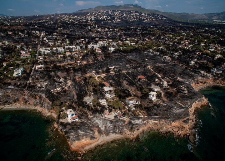 An aerial view shows a burnt area following a wildfire in the village of Mati, near Athens.