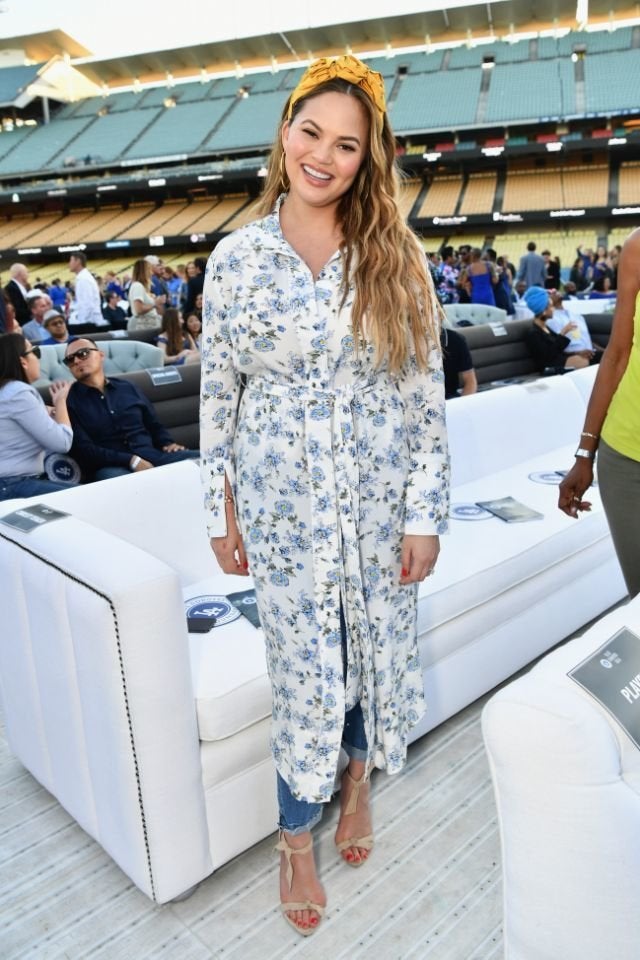 Chrissy Teigen, pictured in June, shared a photo of herself breastfeeding on social media. 