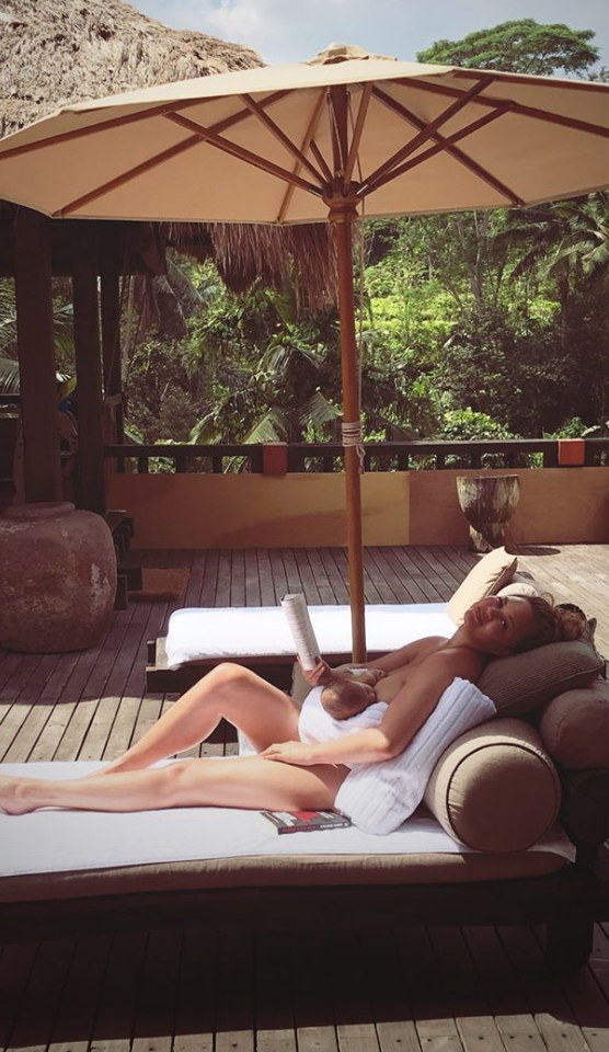 Teigen nurses son Miles while relaxing in Bali. 
