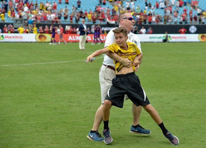 A young fan is stopped by security as he tries to talk to Christian Pulisic of Borussia Dortmund after an International Champions Cup game against Liverpool in Charlotte, North Carolina, on Sunday.