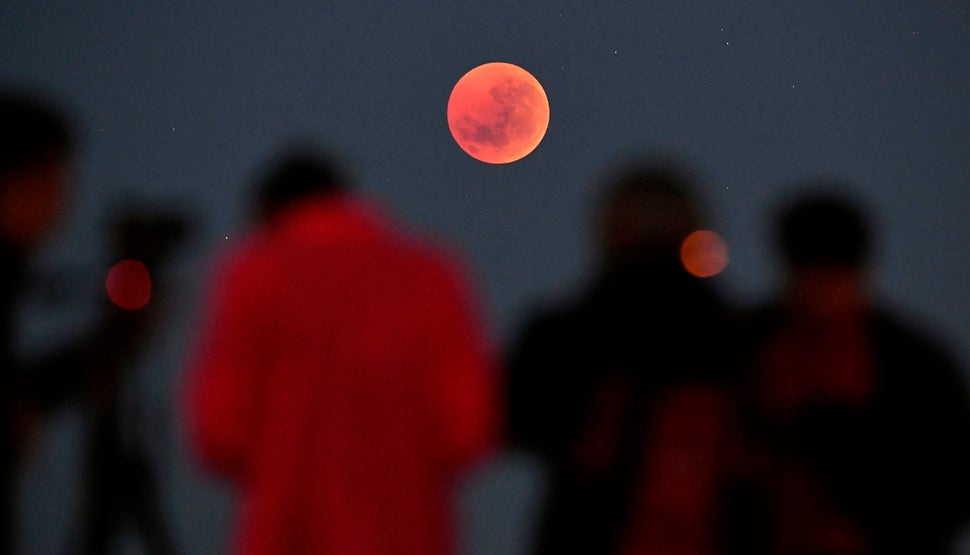 People gather to watch the moon in Melbourne, Australia.