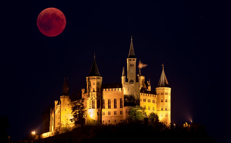 Rising behind the Hohenzollern Castle in Hechingen, Germany.