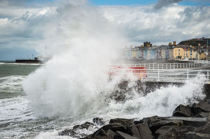 Gale force winds and huge tides combine to bring huge waves crashing into the harbour wall in Aberystwyth on the west Wales coast on Saturday, as the long heatwave finally breaks.