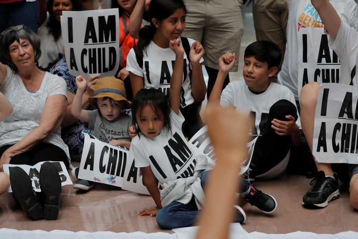 Children and parents participate in a protest in Washington against President Donald Trump's policy that separated immigrant children from their parents.