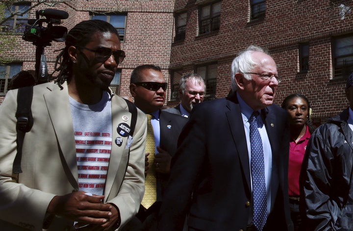 New York City Council member Jumaane Williams walks with then-presidential candidate Sen. Bernie Sanders through a housing complex in Brooklyn in April 2016.