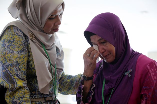 A family member wipes away tears following the release of the report 