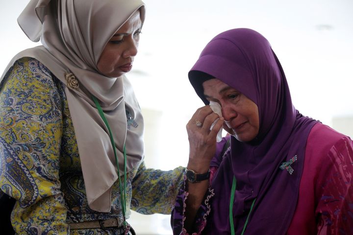 A family member wipes away tears following the release of the report 