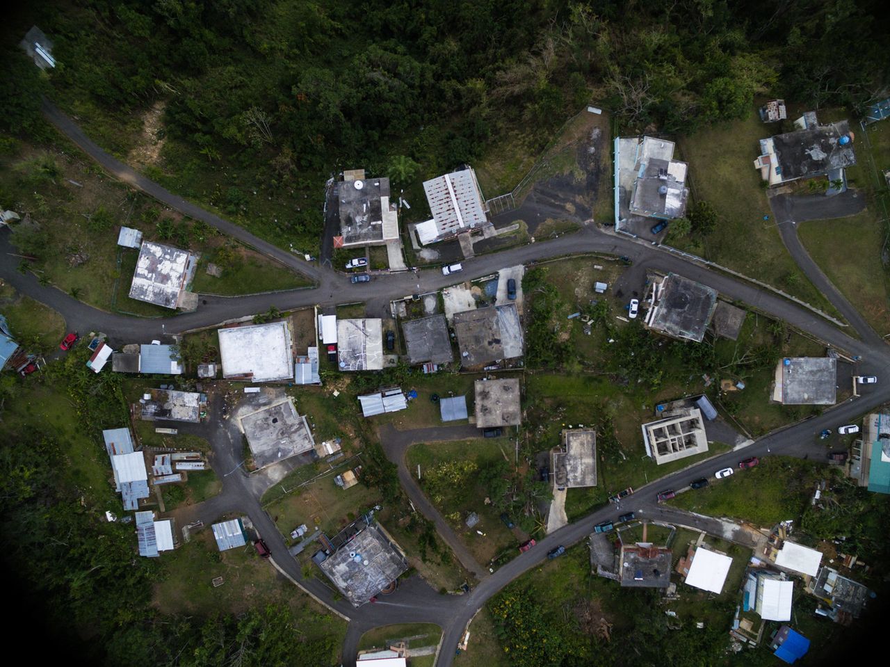 An overhead view of one of the communities Iniciativas De Paz serves reveals that some houses are entirely without roofs, and others are still making do with the tarp roofs installed by FEMA. 