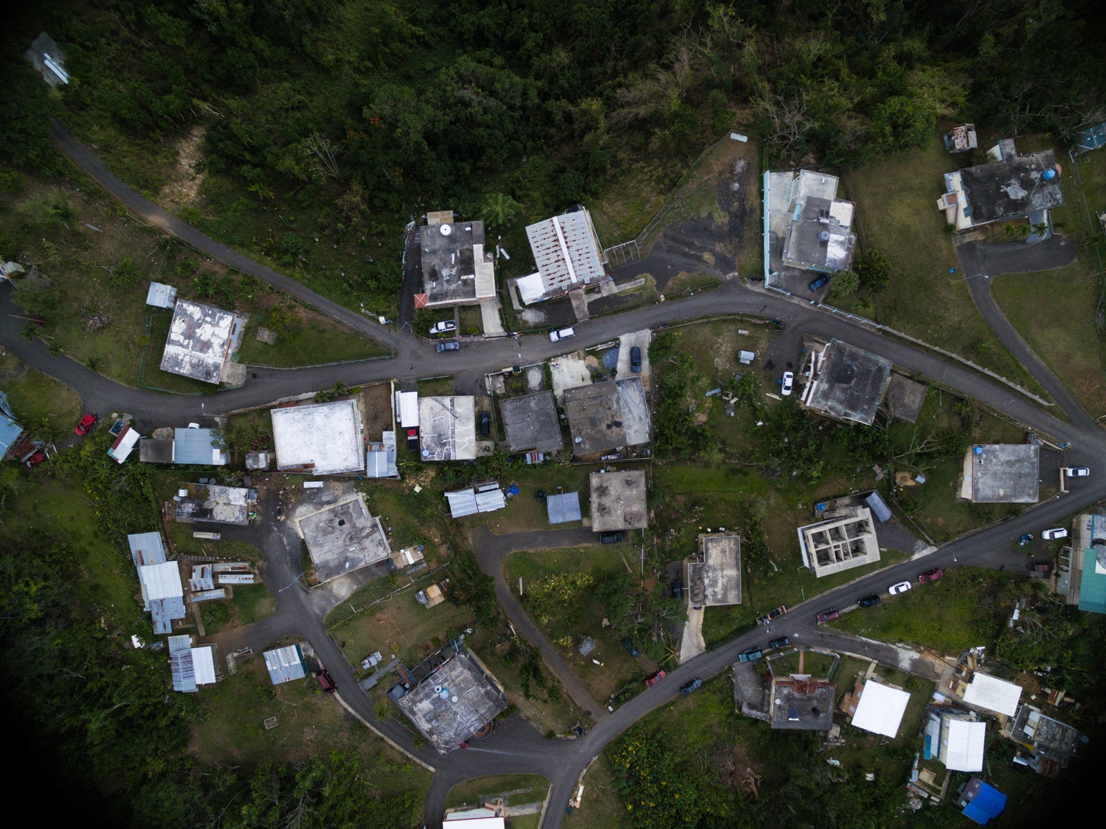 An overhead view of one of the communities Iniciativas De Paz serves reveals that some houses are entirely without roofs, and