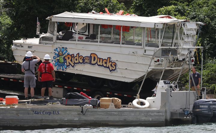 Workers remove an amphibious vehicle that sank in a lake in Branson, Missouri, on July 23.
