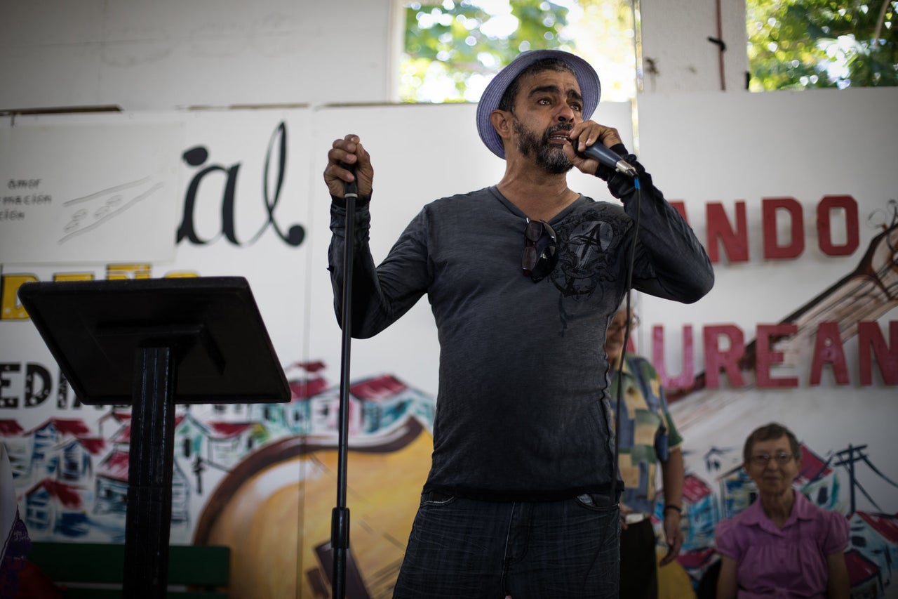 Tito Kayak speaks in front of his church congregation about restoring power to the people of Puerto Rico. The church members chant his name when he pauses for a moment, overcome with emotion. Kayak is a beloved member of his community and well known across the island for his vigilante activism.